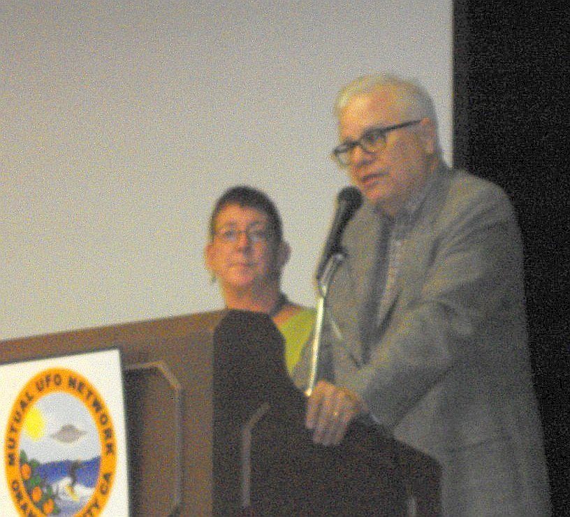 Whitley Strieber and Anne Strieber seated together while giving a presentation to a UFO research audience
