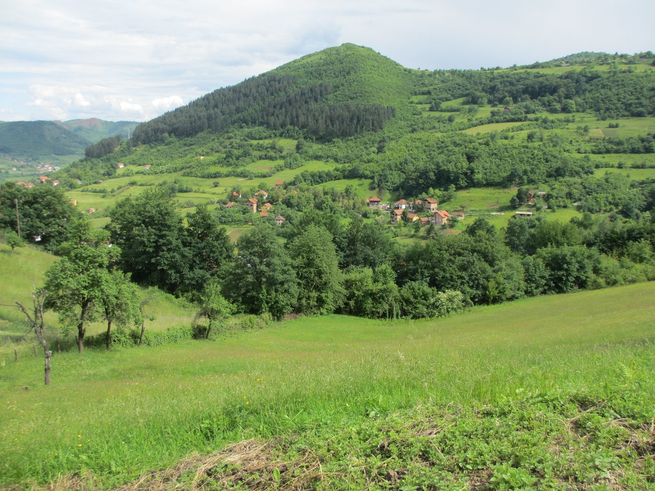 Visočica Hill seen from the road near Visoko, showing its sloped, roughly triangular profile
