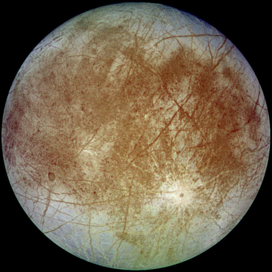 Jupiter's moon Europa, showing dark fracture lines across its bright icy surface, imaged by the Galileo spacecraft.