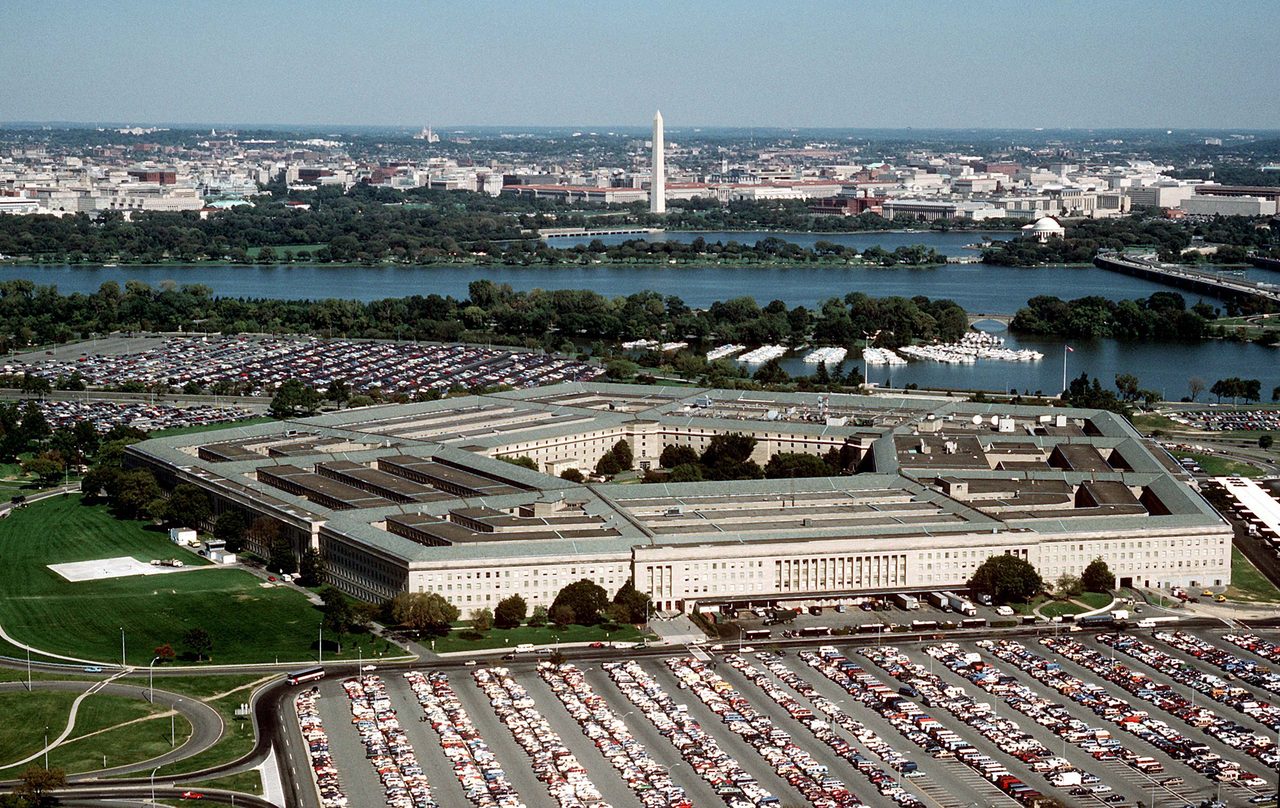 Aerial photograph of the Pentagon viewed from the northeast, with the Potomac River and the Washington Monument in the background