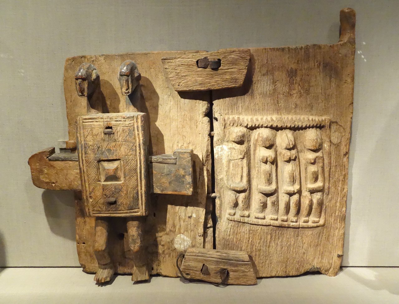 Carved wooden and metal granary shutter, Dogon people, Mali, early 20th century, De Young Museum