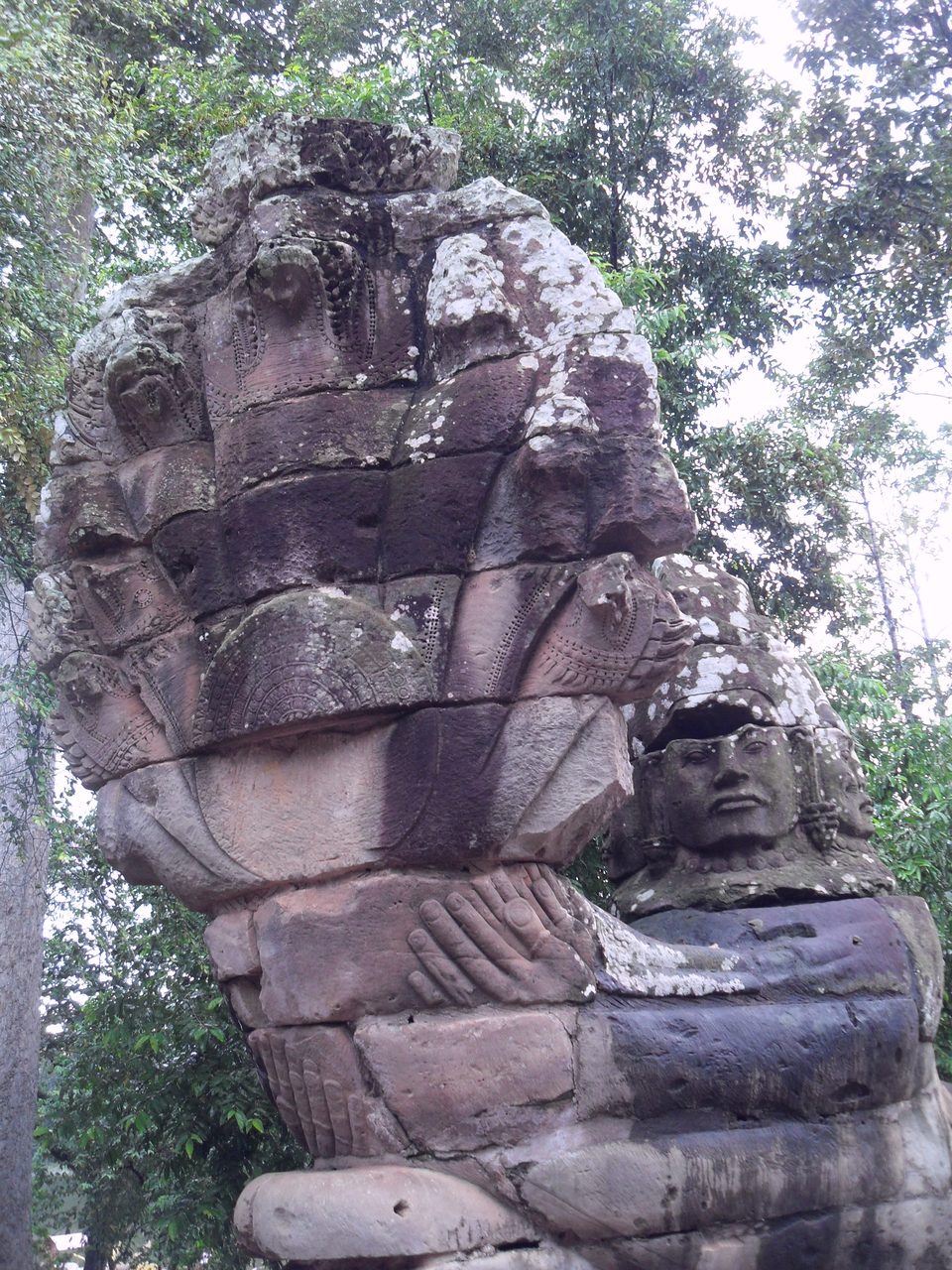 A deva figure holding the seven heads of a naga, Angkor Thom, Cambodia