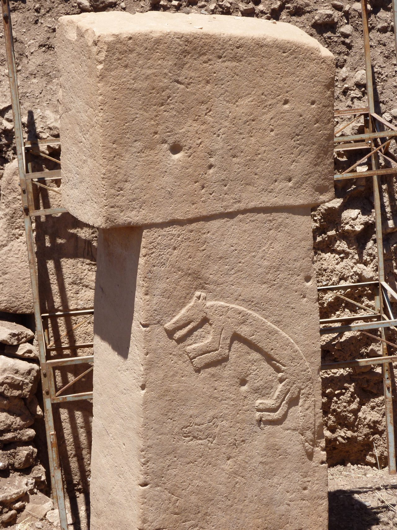 Close-up of a wild animal carved in high relief on a T-shaped limestone pillar at Gobekli Tepe