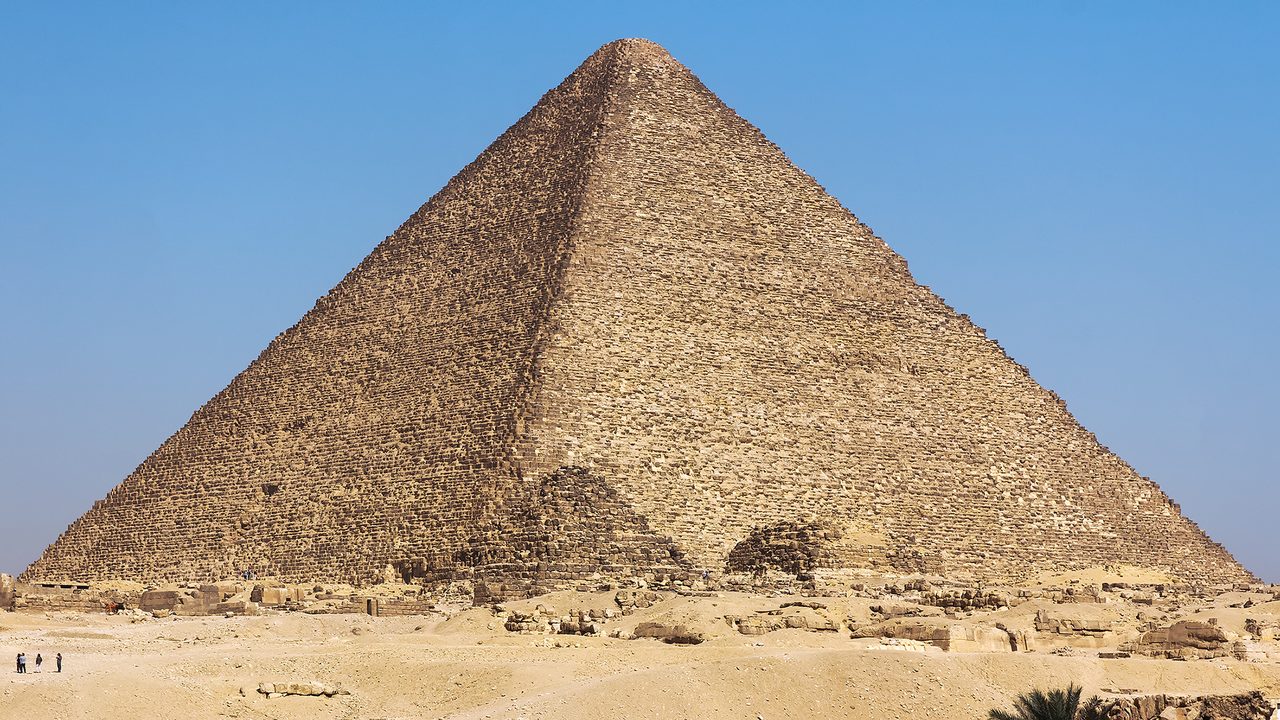The Great Pyramid of Giza rising from the desert against a clear sky