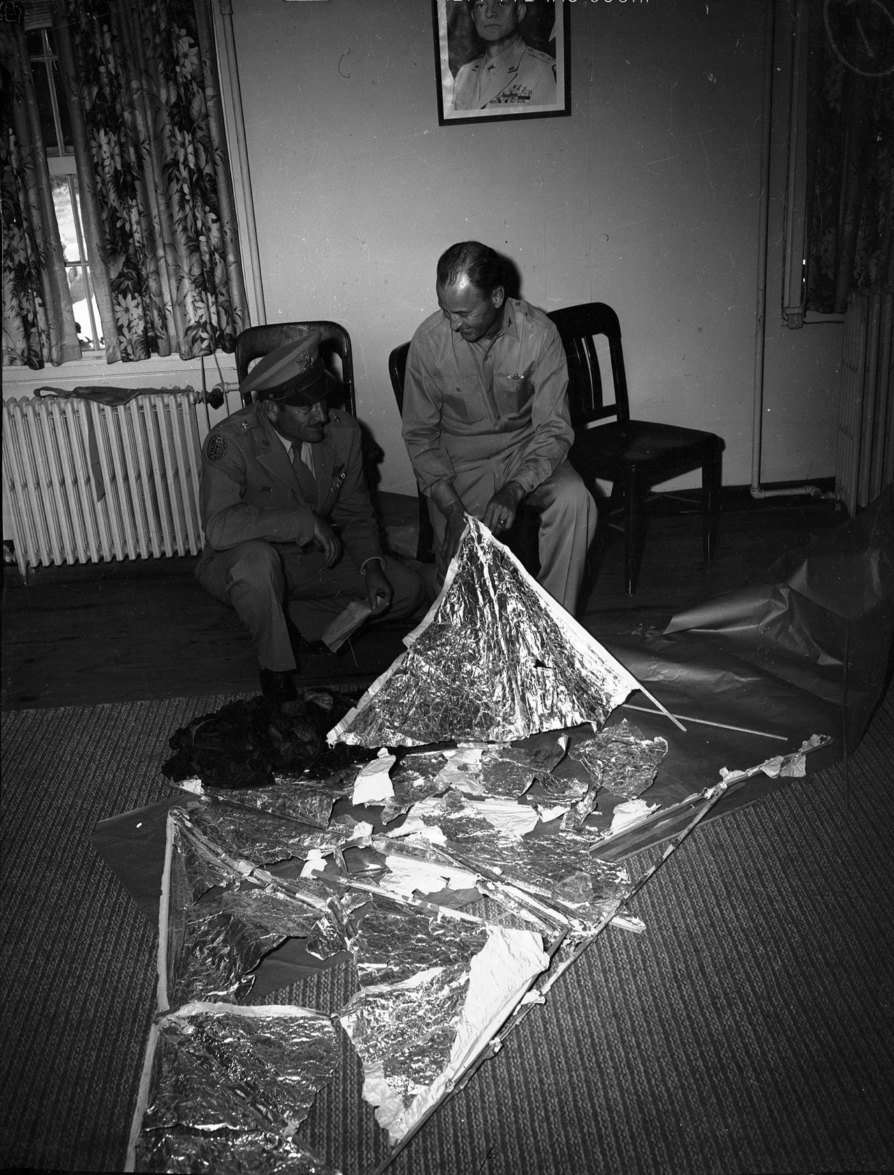 General Roger Ramey and Colonel Thomas DuBose displaying recovered weather-balloon and radar-target debris, Fort Worth Army Air Field, July 8, 1947