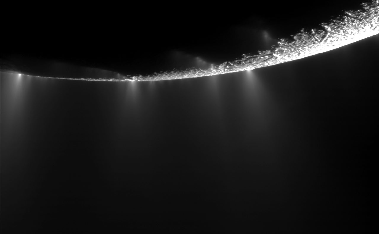 Plumes of water ice and vapor erupting from the south pole of Saturn's moon Enceladus, imaged by the Cassini spacecraft.