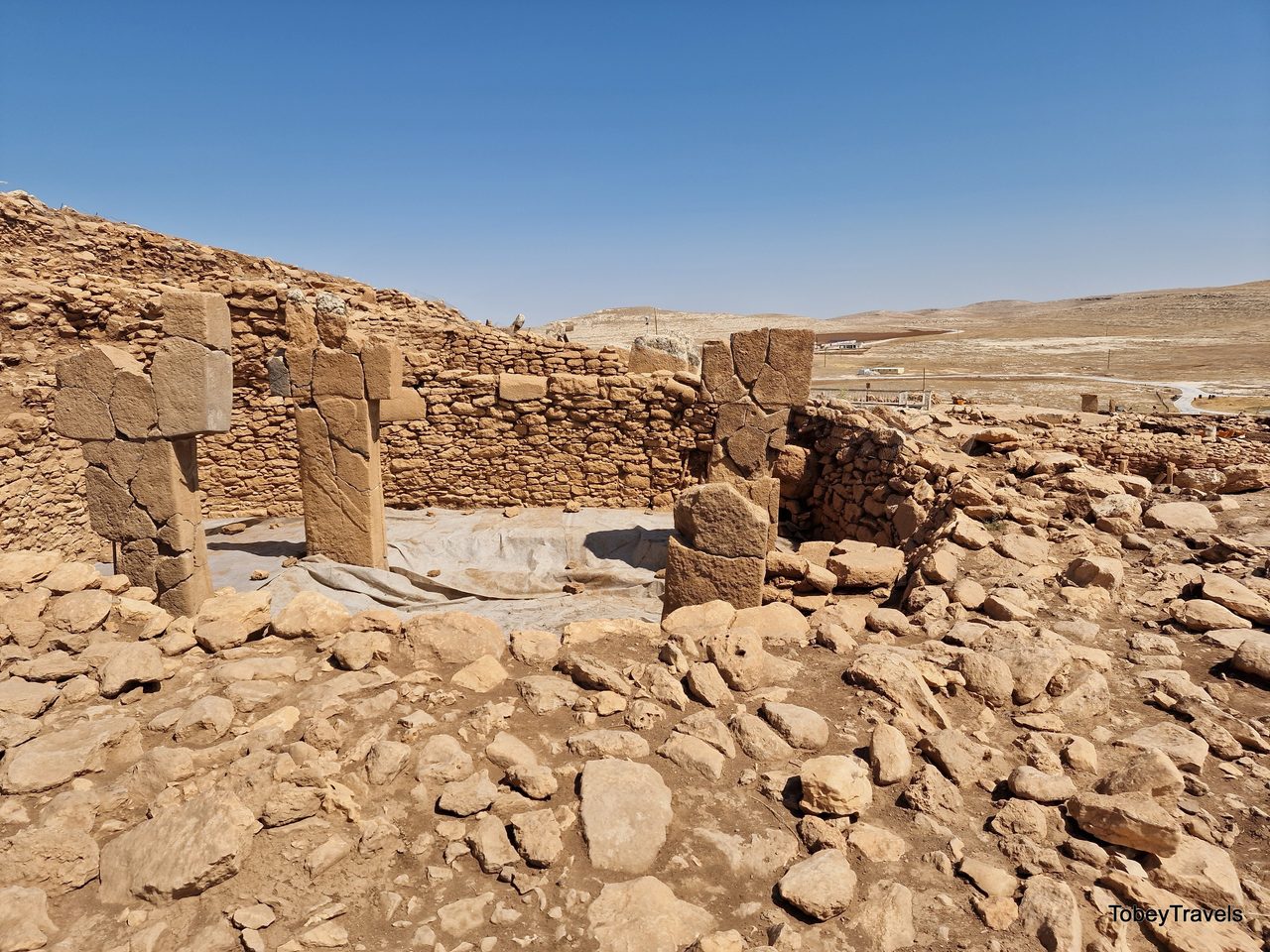 T-shaped limestone pillars standing on the excavated hilltop at Karahan Tepe, Turkey