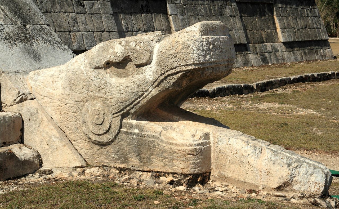Carved stone serpent head at the base of El Castillo's northern staircase, Chichen Itza