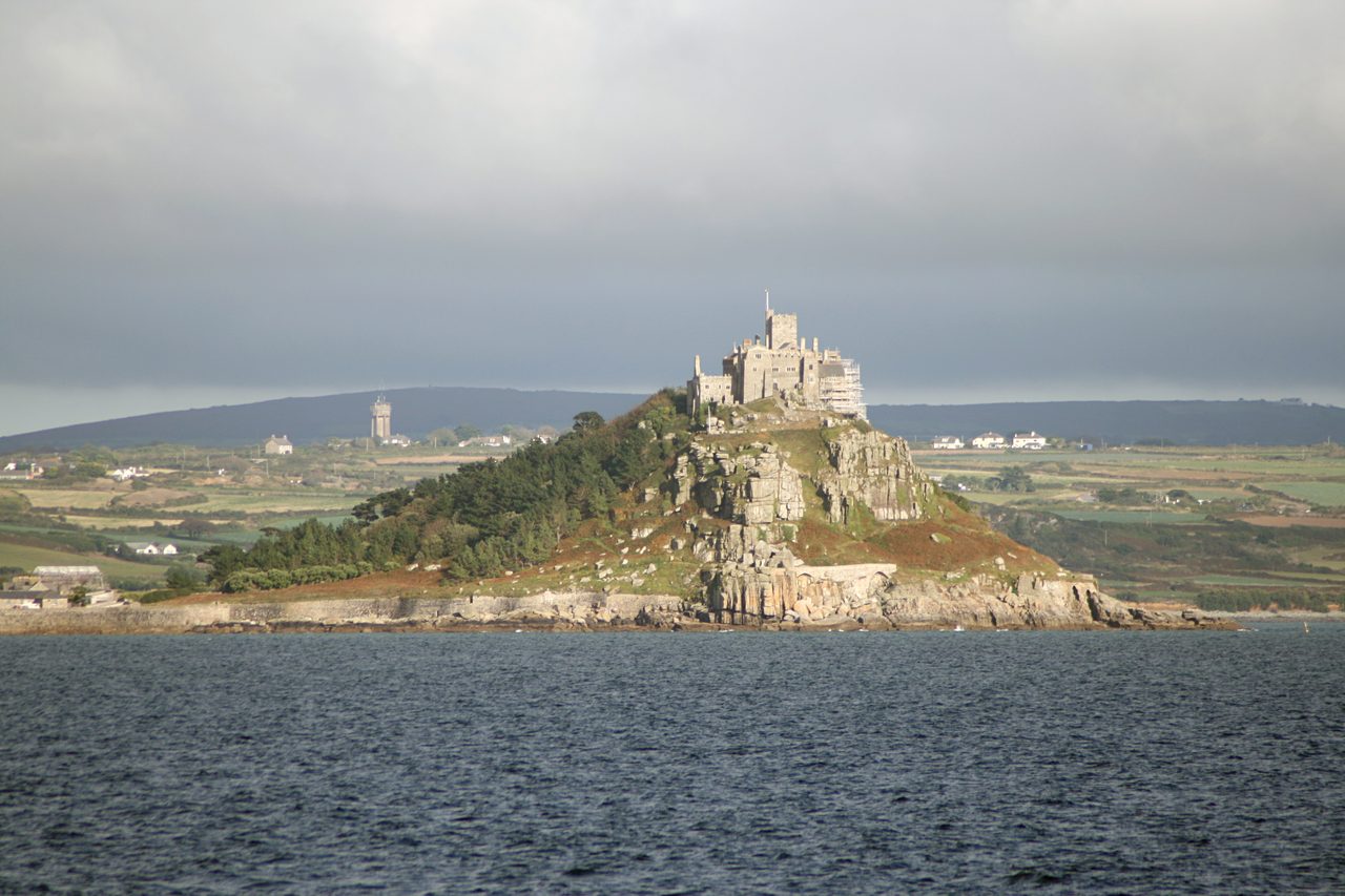 St. Michael's Mount, a tidal island crowned by a castle, seen across the water from the Cornish coast