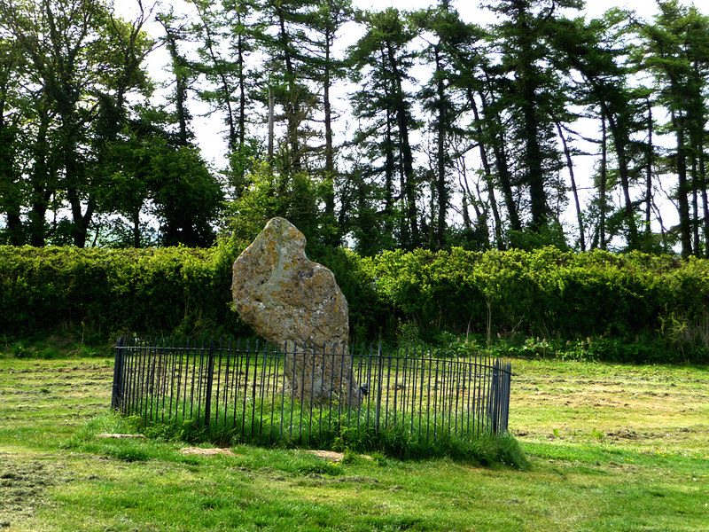 The King Stone, a single weathered standing monolith at the Rollright Stones in Oxfordshire, under an open sky