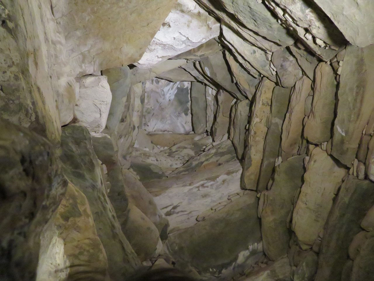 Looking up at the corbelled stone vault inside the Newgrange passage tomb chamber, overlapping slabs rising to a central capstone