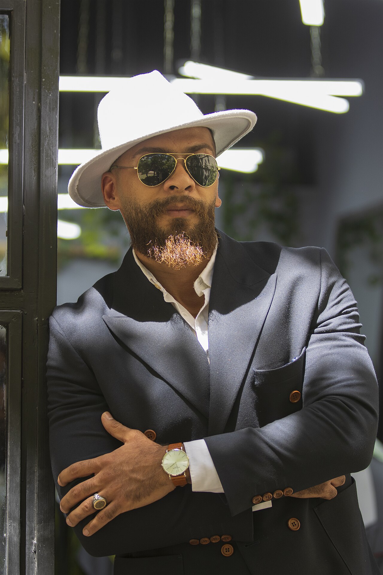 A classic black felt fedora hat on a plain background