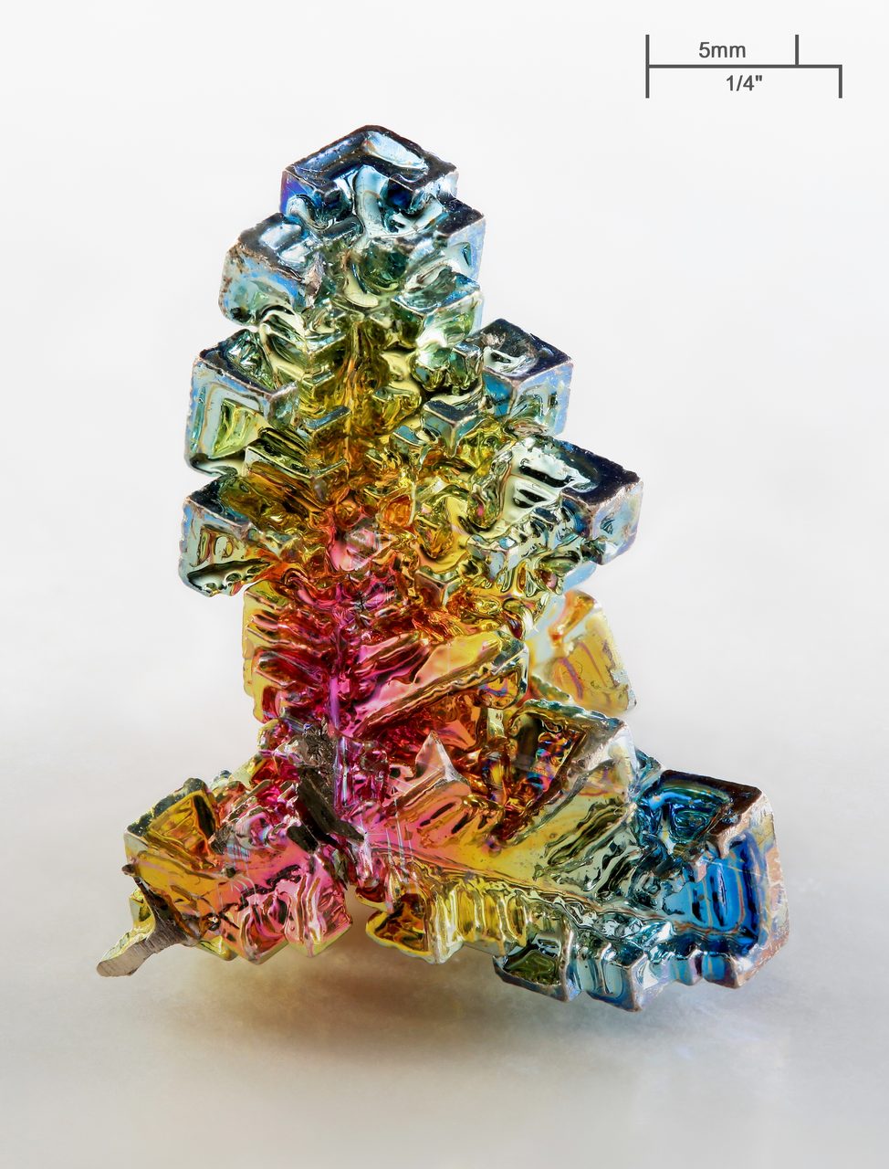 A laboratory-grown bismuth crystal with a rainbow-colored oxidized surface.