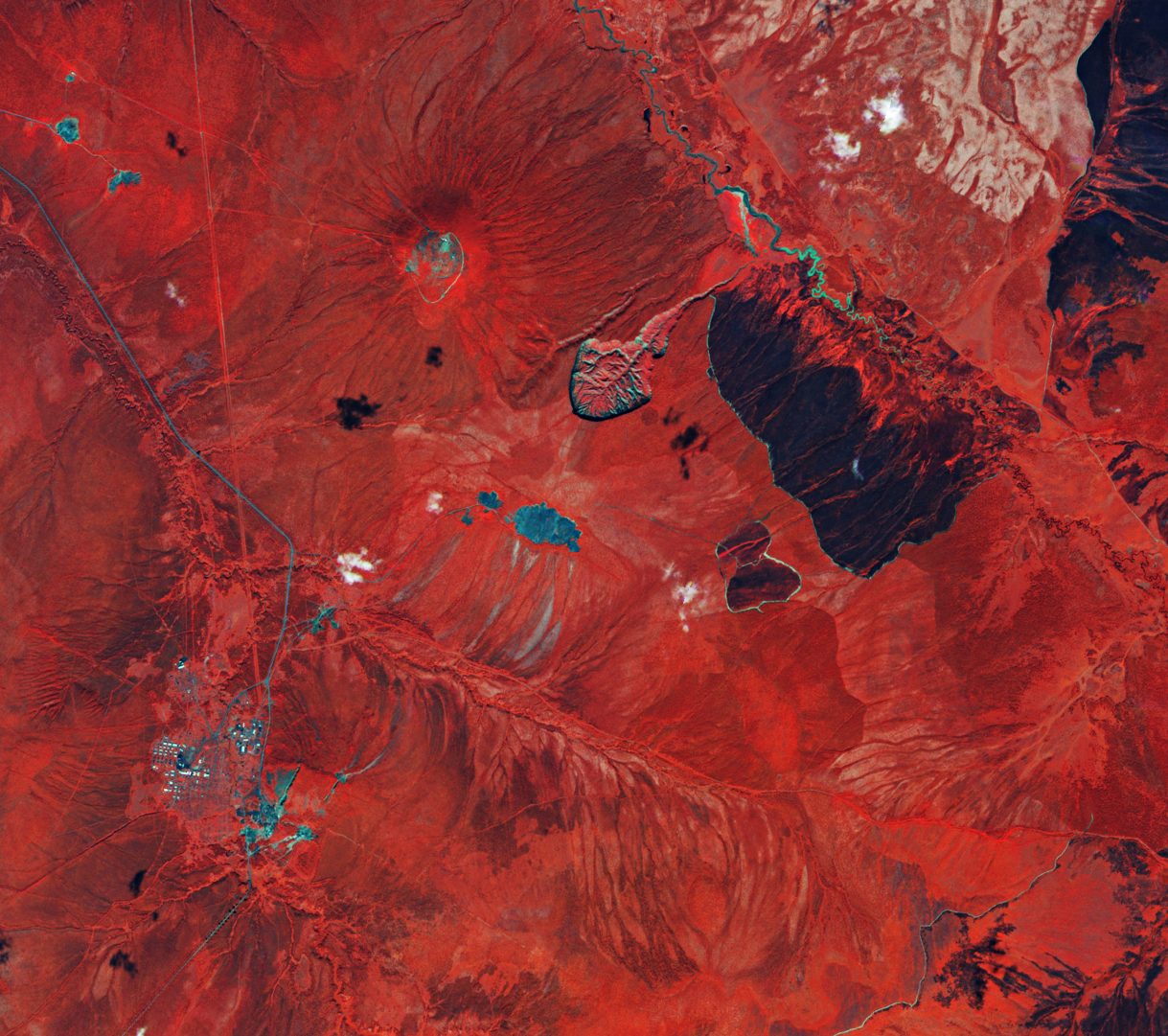 A satellite view of the kilometer-wide Batagaika Crater in Siberia, a vast thermokarst megaslump gouged into the tundra by thawing permafrost.