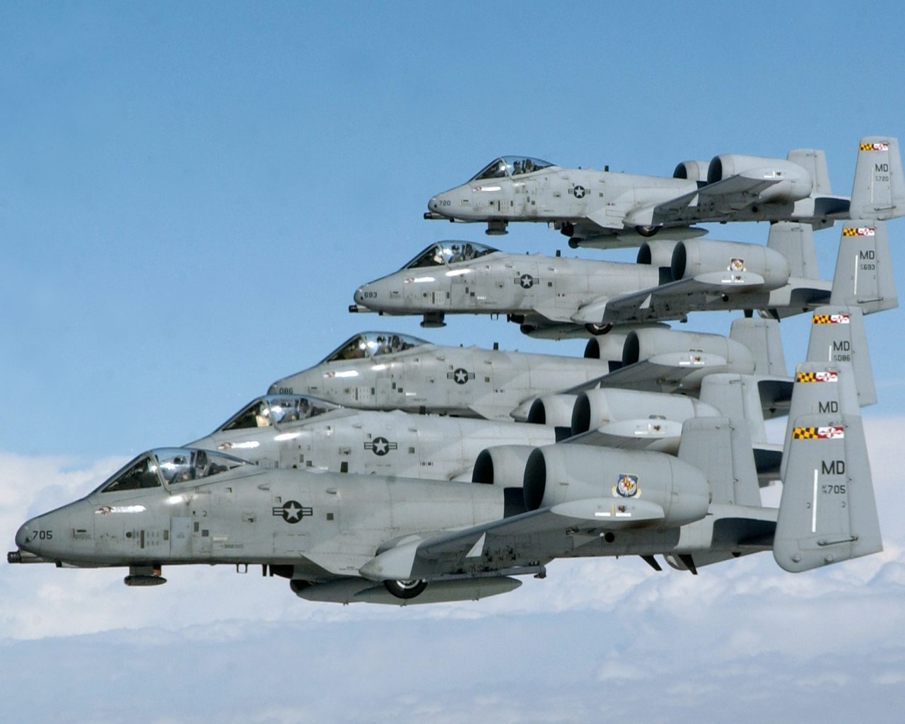 Five A-10 Thunderbolt II aircraft of the 104th Fighter Squadron flying in echelon formation