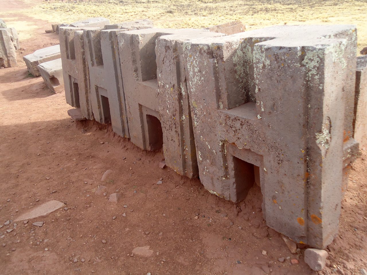 A precisely cut H-shaped sandstone block lying at Puma Punku, Tiwanaku, Bolivia