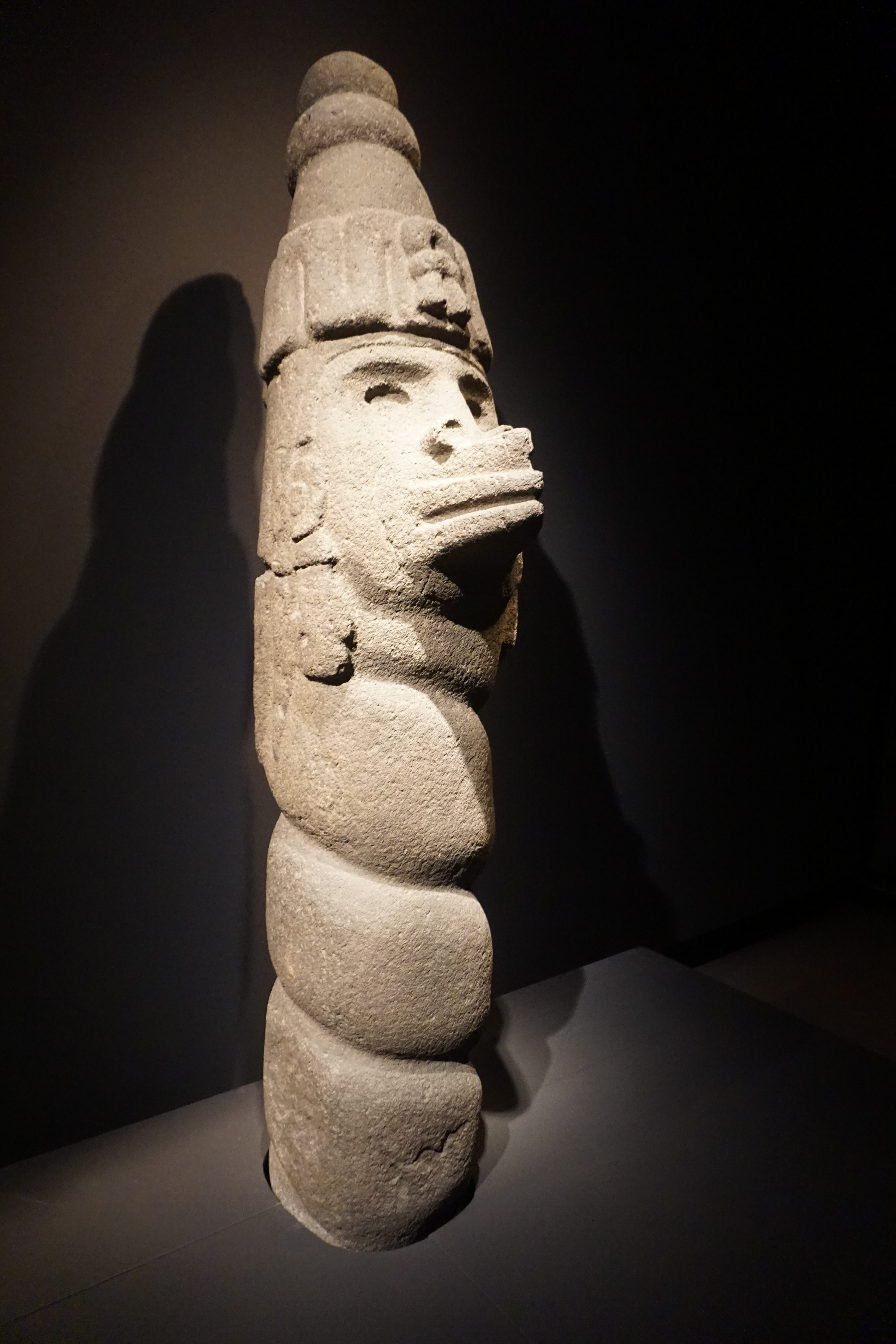 An andesite stone sculpture of Ehecatl, the Aztec wind god, wearing his characteristic beak-shaped wind mask