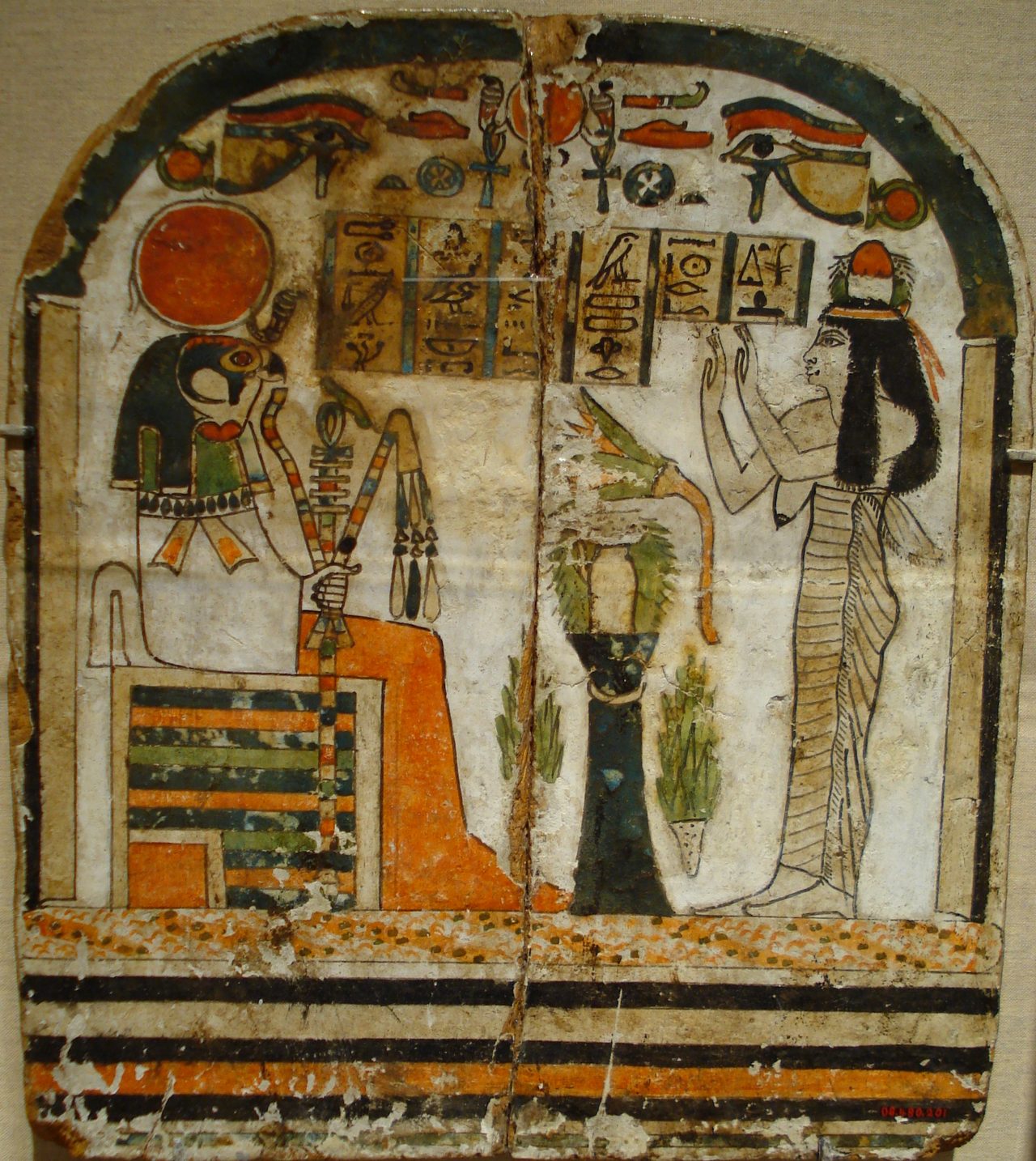 Ancient Egyptian stele showing the god Ra-Horakhty in mummiform aspect receiving worship from a woman named Takhenemet