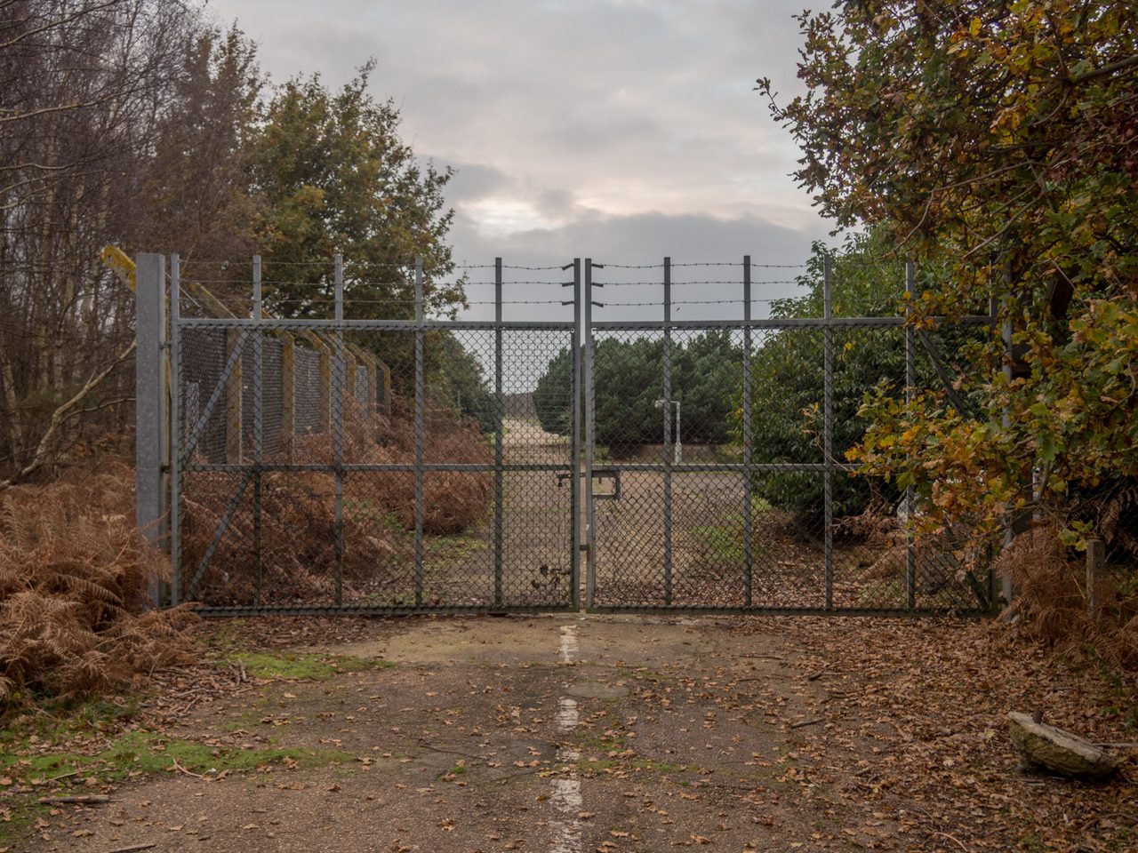 The fence line at the site of the former East Gate of RAF Woodbridge, Suffolk, photographed in 2014