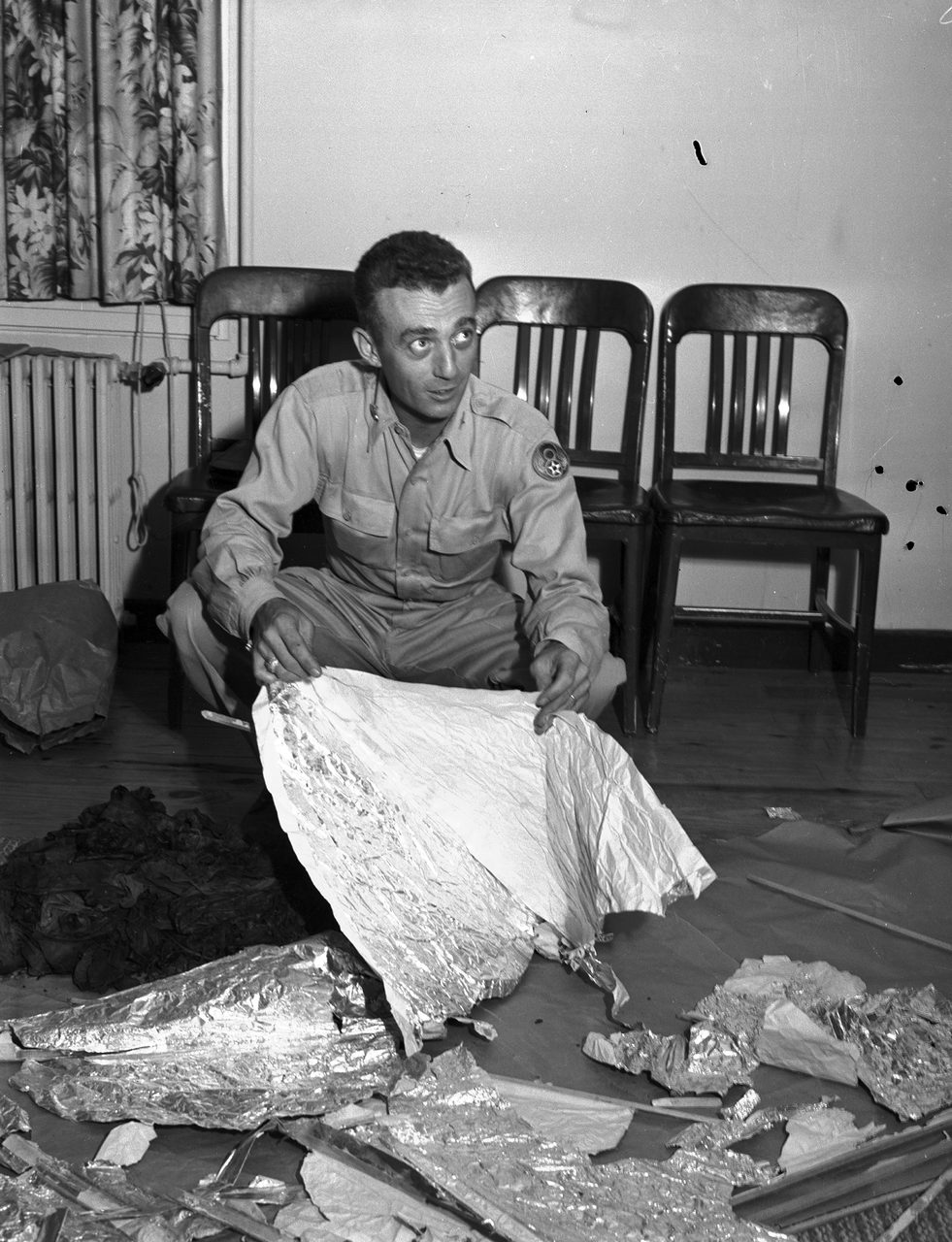 Major Jesse A. Marcel holding metallic foil debris recovered near Roswell, at Fort Worth Army Air Field, July 8, 1947