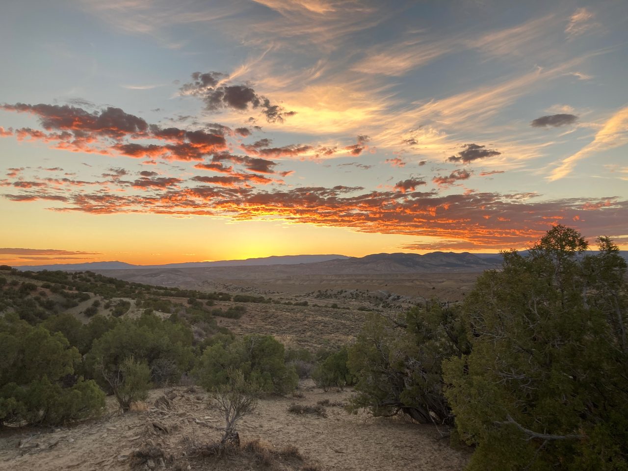 Low golden light over the open high-desert terrain of the Uintah Basin in northeastern Utah