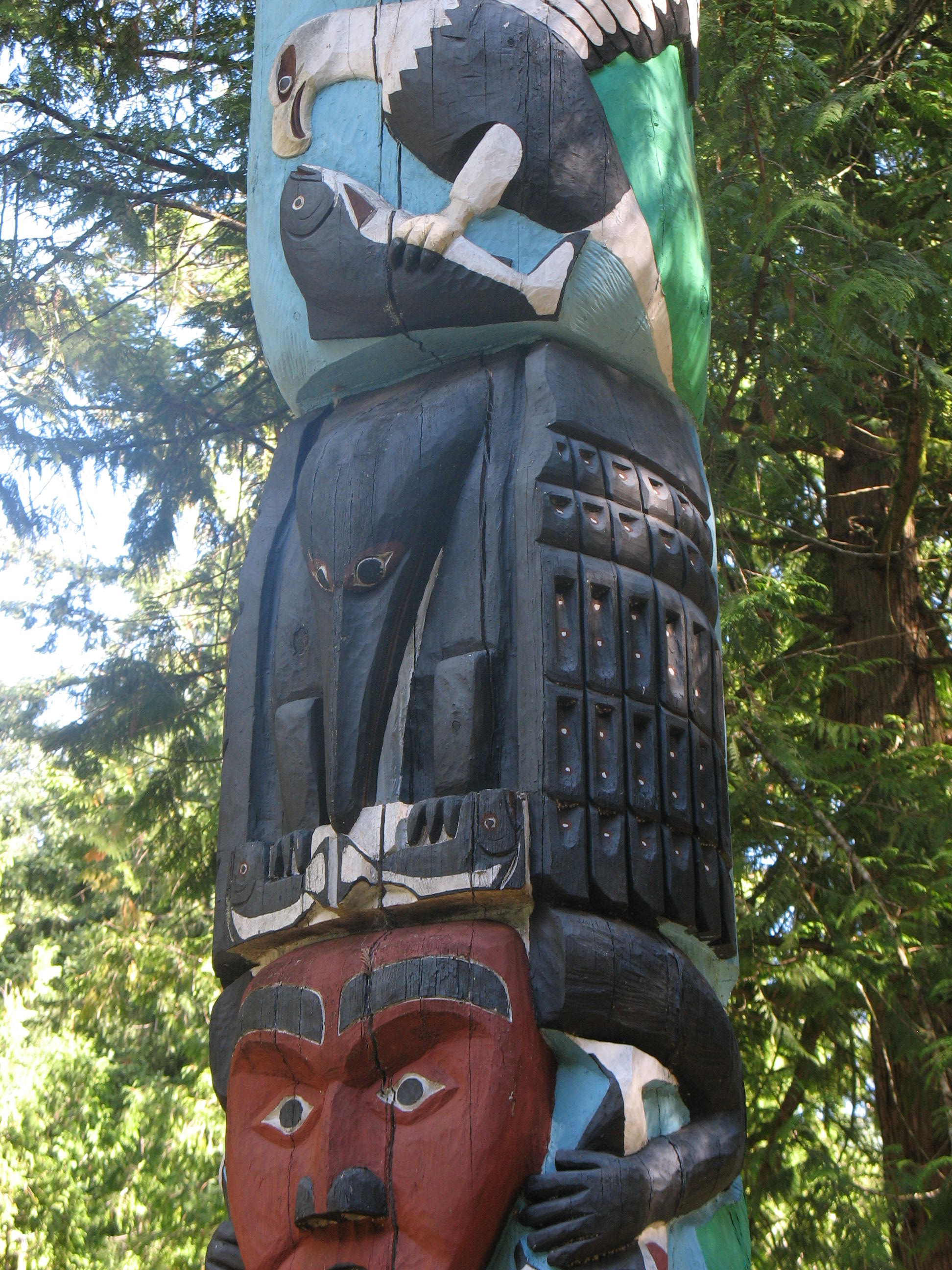A carved raven figure on a Pacific Northwest Coast totem pole