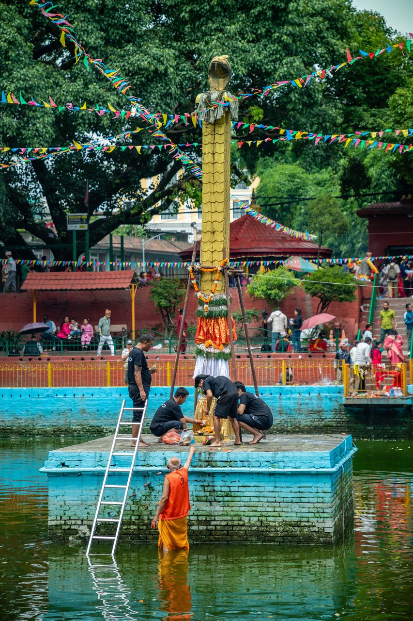Devotee offering prayers at the Naga Panchami festival, Nag Pokhari, Kathmandu, Nepal